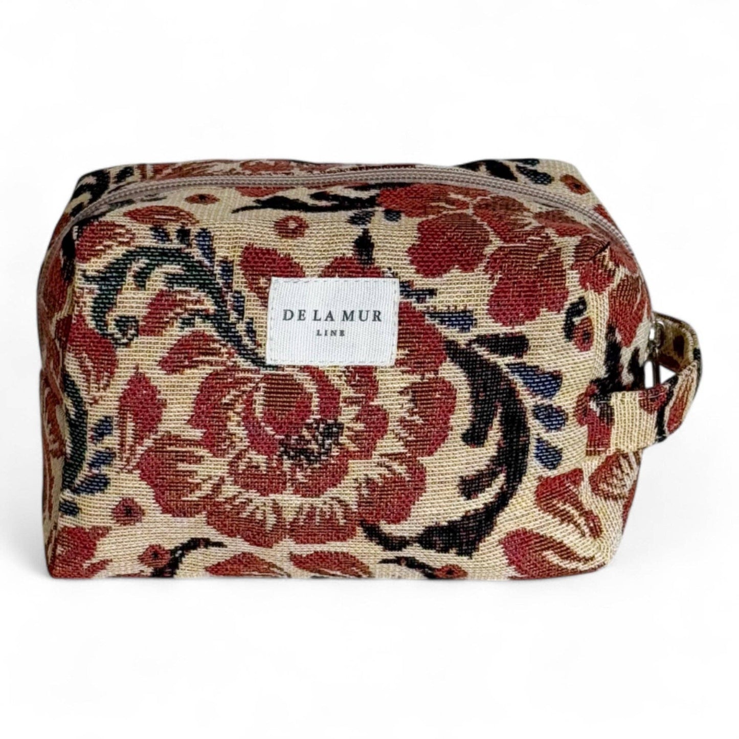 Beauty case in tessuto jacquard floreale beige e rosso con manico laterale.